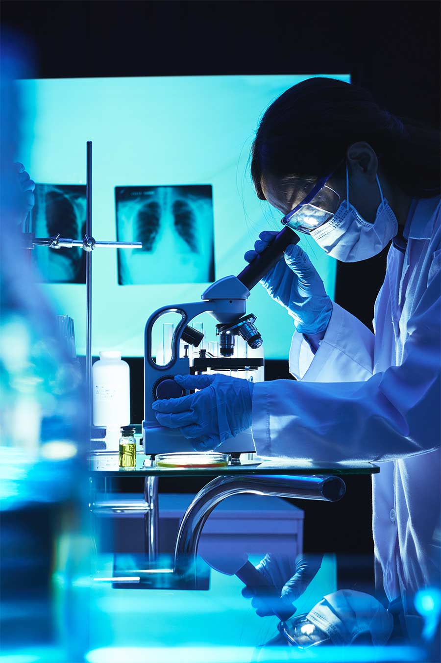 Scientist wearing safety glasses conducting laboratory research and testing